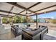 Covered outdoor living area featuring comfortable seating, a ceiling fan, and a view of the pool at 5033 E Turquoise Ave, Paradise Valley, AZ 85253