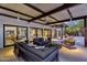 Outdoor patio featuring comfortable seating, ceiling fan, and sliding glass doors for indoor/outdoor living at twilight at 5033 E Turquoise Ave, Paradise Valley, AZ 85253