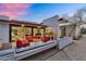 Cozy outdoor patio with modern red furniture, gas fireplace, and view into the living room at 5033 E Turquoise Ave, Paradise Valley, AZ 85253