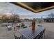 Inviting outdoor patio with a cozy seating area, dining table and a fire pit at 5033 E Turquoise Ave, Paradise Valley, AZ 85253