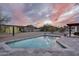Backyard featuring a pool with a baja step, desert landscaping, mountain views and beautiful sunset at 5033 E Turquoise Ave, Paradise Valley, AZ 85253
