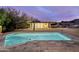 Beautiful backyard with a sparkling pool, inviting fire pit, and a modern glass home at 5033 E Turquoise Ave, Paradise Valley, AZ 85253