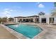 Backyard view of a pool with desert landscaping, and an exterior view of the modern home at 5033 E Turquoise Ave, Paradise Valley, AZ 85253