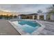 Backyard view of a pool with desert landscaping, and an exterior view of the modern home at dusk at 5033 E Turquoise Ave, Paradise Valley, AZ 85253