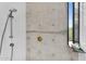Close-up of a concrete wall and shower featuring stainless steel fixtures, and a window at 5033 E Turquoise Ave, Paradise Valley, AZ 85253