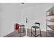 Wine room with a small table and seating and metal shelving with wine bottles and glasses at 5033 E Turquoise Ave, Paradise Valley, AZ 85253