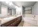 Bright bathroom features double sinks, sleek cabinets, and a soaking tub at 5450 E Deer Valley Dr # 1186, Phoenix, AZ 85054
