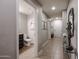 Hallway featuring tile floors, neutral paint, a decorative mirror, and access to a bathroom at 5450 E Deer Valley Dr # 1186, Phoenix, AZ 85054