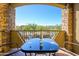 Balcony with a table and chairs, offering a view of the surrounding landscape and clear blue sky at 5450 E Deer Valley Dr # 2023, Phoenix, AZ 85054