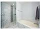 Bathroom featuring glass shower and marble tub at 5450 E Deer Valley Dr # 2023, Phoenix, AZ 85054