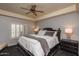 Well-lit bedroom featuring a ceiling fan and comfortable, stylish bedding at 5450 E Deer Valley Dr # 2023, Phoenix, AZ 85054