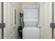 A stacked washer and dryer unit is featured in a compact closet with white doors at 5450 E Deer Valley Dr # 2023, Phoenix, AZ 85054