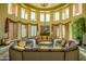 Elegant living room with a rounded seating area, beautiful window and lush indoor plants at 5450 E Deer Valley Dr # 2023, Phoenix, AZ 85054