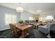 Living room with a fireplace, chandelier, hardwood dining table, and stylish furnishings at 5450 E Deer Valley Dr # 2023, Phoenix, AZ 85054