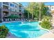 Beautiful community pool area with palm trees, waterfall feature, and lounge chairs for relaxation and leisure at 5450 E Deer Valley Dr # 2023, Phoenix, AZ 85054