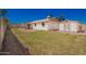 The backyard features a storage shed, grass and hardscape areas, ideal for outdoor activities and storage at 547 E Sack Dr, Phoenix, AZ 85024