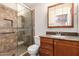 Updated bathroom featuring granite countertops, stylish tiled shower with glass door, and modern fixtures at 547 E Sack Dr, Phoenix, AZ 85024
