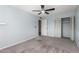 Comfortable bedroom with carpet flooring, a ceiling fan, and double closet for storage at 547 E Sack Dr, Phoenix, AZ 85024