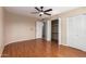 Large bedroom featuring laminate floors, a ceiling fan, and double closet for storage at 547 E Sack Dr, Phoenix, AZ 85024