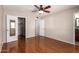 Spacious bedroom with hardwood floors, a ceiling fan, and a walk-in closet at 547 E Sack Dr, Phoenix, AZ 85024