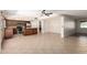 Open concept living space with tiled floors connecting the kitchen to the dining and living areas at 547 E Sack Dr, Phoenix, AZ 85024