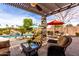Covered patio features outdoor seating and dining with views of the pool, spa, and lush landscaping at 560 W Powell Way, Chandler, AZ 85248