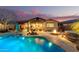 Inviting backyard oasis featuring a sparkling pool, spa, fire pit, and covered patio perfect for outdoor entertaining at 560 W Powell Way, Chandler, AZ 85248