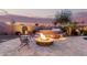 Cozy backyard showcasing a fire pit and hot tub area with comfortable seating, perfect for outdoor relaxation and enjoyment at 560 W Powell Way, Chandler, AZ 85248