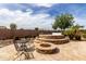 Outdoor patio with fire pit, table, and hot tub, perfect for relaxation and entertaining at 560 W Powell Way, Chandler, AZ 85248
