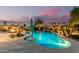 Lush backyard showcasing a stunning pool with a waterfall feature, inviting seating area, and ample space for outdoor enjoyment at 560 W Powell Way, Chandler, AZ 85248