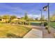Community basketball court bordered by manicured bushes, trees, walkway, and lamp post at 560 W Powell Way, Chandler, AZ 85248