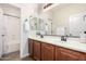 Bathroom with a large vanity featuring double sinks, a large mirror, and access to the shower/tub at 560 W Powell Way, Chandler, AZ 85248