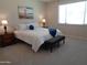 Comfortable bedroom with a Golden Gate Bridge picture, two side tables and lamps, and plush carpet at 560 W Powell Way, Chandler, AZ 85248