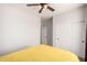 Bedroom featuring neutral colors, a ceiling fan, and a view of the closet and doorway at 560 W Powell Way, Chandler, AZ 85248