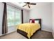 Bedroom with a dark wood bed frame and a bright window featuring curtains at 560 W Powell Way, Chandler, AZ 85248