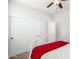Well-lit bedroom with white sliding door closet and a view of an open doorway at 560 W Powell Way, Chandler, AZ 85248