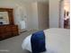 Open primary bedroom leading to the en-suite bathroom featuring plush carpets and door to the backyard at 560 W Powell Way, Chandler, AZ 85248