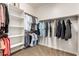 Walk-in closet with built-in shelving and rods offering ample storage for clothing and accessories at 560 W Powell Way, Chandler, AZ 85248