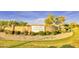 Snedigar Sportsplex entrance featuring brick signage surrounded by gravel, bushes, and grassy areas at 560 W Powell Way, Chandler, AZ 85248