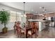 Elegant dining room with wooden table set, chandelier lighting, and seamless transition into the open kitchen area at 560 W Powell Way, Chandler, AZ 85248