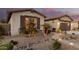 Exterior view of home with stone accents, desert landscaping, pathway, and well-manicured curb appeal at 560 W Powell Way, Chandler, AZ 85248