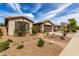 A street view showcasing a well-maintained home with desert landscaping and a charming brick pathway at 560 W Powell Way, Chandler, AZ 85248