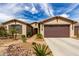 Inviting single-story home with a two-car garage and desert-friendly landscaping at 560 W Powell Way, Chandler, AZ 85248