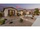 A row of homes is complemented by desert landscaping, a paved walkway, and warm exterior lighting at 560 W Powell Way, Chandler, AZ 85248