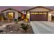 Front exterior of home featuring desert landscaping, decorative outdoor lighting, and covered entryway at 560 W Powell Way, Chandler, AZ 85248