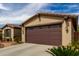 A close up of a two car garage with desert landscaping at 560 W Powell Way, Chandler, AZ 85248