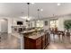 Gourmet kitchen with granite countertops, stainless steel appliances, and seamless flow into the living area at 560 W Powell Way, Chandler, AZ 85248