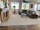 Spacious living room features a stone fireplace, plush carpeting, and an abundance of natural light at 560 W Powell Way, Chandler, AZ 85248