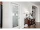 Pantry door with decorative frosted glass and a chest of drawers in the hallway at 560 W Powell Way, Chandler, AZ 85248