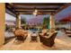 Relaxing outdoor patio area with comfortable seating overlooking a beautiful pool and lush landscaping at 560 W Powell Way, Chandler, AZ 85248